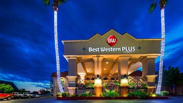 Pacific Plaza Hotels | Alameda, California | Night view of Best Western Plus hotel exterior with palm trees